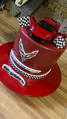 a red cake with a car on top