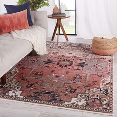 a living room with a couch and rug on the floor