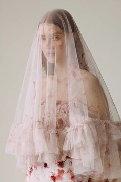 a woman wearing a veil with flowers on it