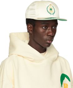 Polyester satin cap in off-white. · Embroidered eyelets at crown · Logo graphic embroidered at face · Graphics embroidered at flat brim · Snapback fastening · Partial twill lining Supplier color: Off white White Flat Crown Baseball Cap For Streetwear, White Snapback Hat For Streetwear With Flat Crown, White Adjustable Baseball Cap With Flat Crown, Cream Embroidered Snapback Baseball Cap, White Adjustable Snapback Hat With Flat Crown, Adjustable White Baseball Cap With Flat Crown, White Cotton Flat Brim Fitted Hat, White Cotton Fitted Hat With Flat Brim, Casual White Hat With Flat Crown