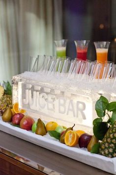 an ice bar with fruit and glasses on it