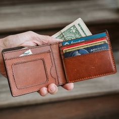 Inspired by the wild and untamed wilderness, where the spirit of adventure thrives, lies the Roosevelt Billfold Wallet. A classic billfold wallet crafted with the rugged elegance of water buffalo leather in full-grain texture bears the marks of a life lived in pursuit of the extraordinary. The richness of its water buffalo leather and suede interior is a testament to nature's enduring beauty. You'll find a prominent display for your photo ID, a window into your narrative. Four sturdy slots on th Rugged Leather Bifold Wallet, Rugged Leather Wallet With Coin Pocket, Rugged Bifold Wallet For Everyday Use, Rustic Bifold Wallets For Everyday Use, Bifold Waxed Finish Wallets For Everyday Carry, Dark Brown Leather Jacket, Idea Box, Wallet Craft, Leather Billfold