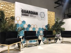 a group of black chairs sitting on top of a white floor next to a wall