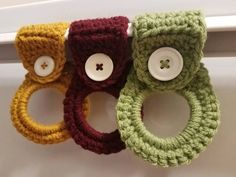 three crocheted rings with buttons on them