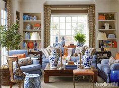 a living room filled with blue and white furniture