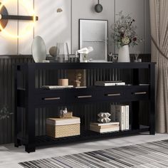 a black console table with drawers and shelves