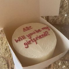 a birthday cake in a box that says, will you be my girlfrue?