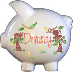 a white piggy bank with monkeys on it's side and the word dany written in orange