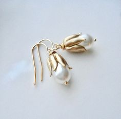 Bridgerton Style White Pearl and Gold Drop Earrings. These beautiful earrings are made from vintage raw brass bead caps, Swarovski white cream pear shaped pearls and gold plated findings. They are about 1" tall. Check out my store to see more of my creations http://www.etsy.com/shop/anechkasjewelry Thank you for looking! Wedding Jewelry Bridesmaids, Bridgerton Style, White Pearl Earrings, Wedding Bridesmaid Jewelry, White Pearl Earring, Gold Pearl Earrings, Christmas Gift For Her, Earrings In Gold, Swarovski Earrings