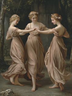 three women in long dresses are holding each other's hands while standing next to trees