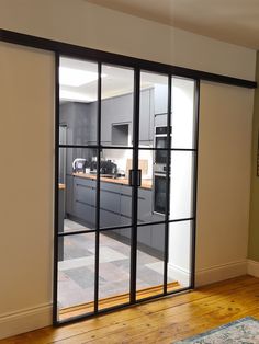 an open kitchen with sliding glass doors leading into the dining room