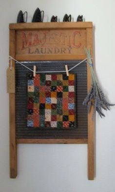 a wooden sign with a quilt hanging from it's side and several pairs of shoes on the clothesline