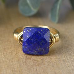 "Faceted Square Lapis Lazuli Gemstone and Sterling Silver, Yellow or Rose Gold Filled Wire Wrapped Ring; Custom Made to Size MATERIALS: ❀This faceted square lapis lazuli gemstone bead and wire wrapped ring is handmade with an approximately 10mm by 10mm gemstone bead and your choice of wire band. ❀ The wire ring band choices are Sterling Silver Filled wire, Argentium Sterling Silver wire (tarnish resistant sterling silver wire), Yellow Gold Filled wire, or Rose/Pink Gold Filled wire. ❀ This listi Handmade Adjustable Lapis Lazuli Rings, Handmade Lapis Lazuli Ring, Rectangular Hand Wrapped Jewelry Gift, Handmade Lapis Lazuli Jewelry For Anniversary, Lapis Lazuli Ring, Diy Rings, Hand Stamped Jewelry, Wire Wrapped Rings, Argentium Silver