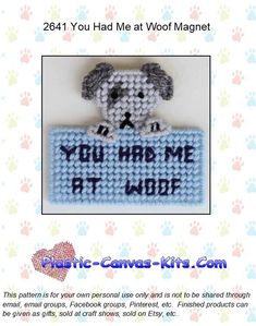 a crocheted dog holding a sign that says you had me at wolf magnet