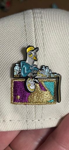 "1.25 inch soft enamel double prong pin This pin of the pigeon, \"Cap\" is the 18 pin in a series to feature this character.  Be sure to grab this pin while you can to complete your collection." Cool Hat, The Pigeon, Soft Enamel, Stick Pins, Cool Hats, Hat Pins, Ball Cap, Lapel Pin, Pigeon