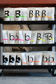 three tiered cart with coffee bags on it and the letters bb, b, c, d