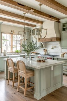 a kitchen with two chairs and an island in the middle, surrounded by wood beams