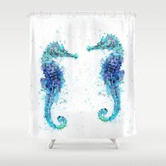 a shower curtain with two seahorses painted on it's sides and watercolor paint splatters all over them