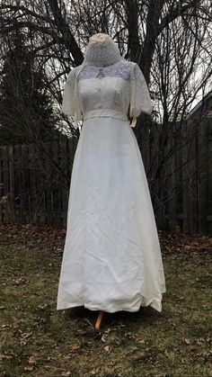 a wedding dress on display in the yard