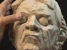 a person making a face out of clay