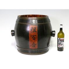 Very useful old large Chinese wooden storage barrel in traditional design with knobbed handles from the late Qing period. Completely hand made using convex staves held together by brass hoops. Columns of Chinese calligraphic characters on the front and back painted in black over a swath of natural finished wood which makes a beautiful contrast against the dark varnished main body. This large storage vessel can be used for so many things from dry flower arrangements to storage of wood, towels mag Dry Flower Arrangements, Coffee Table Base, Back Painting, Dry Flower, Brass Hoops, Wine Barrel, Dried Flower Arrangements, Wooden Storage, Qing Dynasty