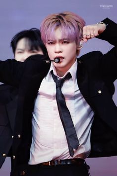 a man with purple hair wearing a black tie