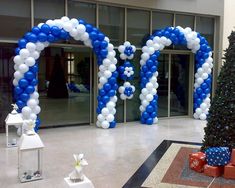 an entrance decorated with balloons and presents