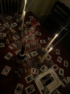 candles are lit on the table with cards scattered around