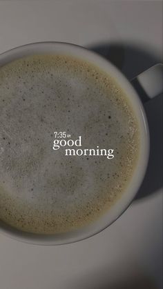 a cup of coffee with the words good morning written in white letters on it's side