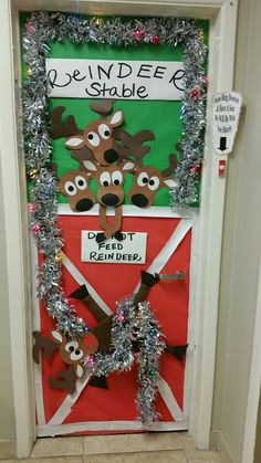 a door decorated with tinsel and reindeers for the holiday season is shown in front of a bulletin board