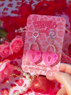 This listing is for ONE Pair of Pink Heart Locket Earrings. lever backs are hypoallergenic. If you wish to replace hardware to hooks, ball posts, clip-ons  please leave me a note at checkout. Earrings are approximately 1.75" Follow me on IG for shop updates! @shopcosmiclovely Subscribe to my newsletter for exclusively monthly coupons! You can subscribe at: cosmiclovely.com Kawaii Jewelry Aesthetic, Pink Hypoallergenic Earrings For Valentine's Day, Valentine's Day Hypoallergenic Double Heart Earrings, Personalized Earrings For Valentine's Day, Personalized Heart Hoop Earrings For Valentine's Day, Valentine's Day Gift Hoop Earrings, Vtuber Reference, Silly Earrings, Lock Earrings