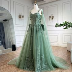 a green wedding dress on display in a room