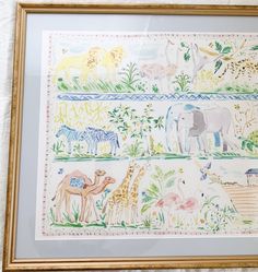 a painting with animals and plants on it in a gold frame hanging on the wall