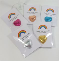 four heart shaped candy bags with thank you so much written on them and rainbows in the background