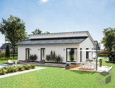 a small white house sitting in the middle of a lush green field next to a swimming pool