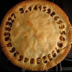 an uncooked pie sitting on top of a stove with the letters spelled out