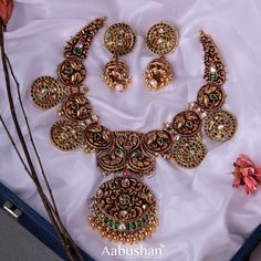 an elaborate necklace and earring set on display