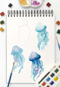 the watercolors are being used to paint jellyfish