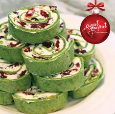 a white plate topped with green and red desserts