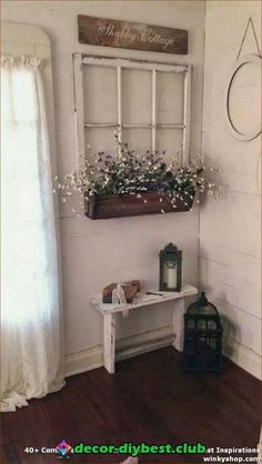 a room with white walls and wooden flooring has a window, potted plant on the wall