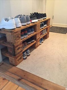 several pairs of shoes are stacked on wooden crates