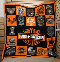 an orange and black harley davidson blanket with patches on it