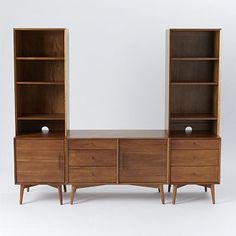 an old wooden dresser with two open shelves and one closed shelf on each side, against a white background