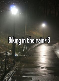 the words biking in the rain - 3 are lit up at night