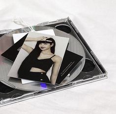 a cd case with an image of a woman in black on the front and inside