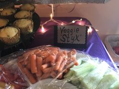 carrots, celery, and other vegetables are on display in plastic bags