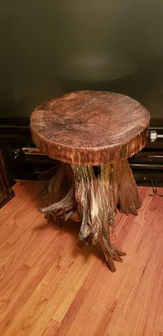 a tree stump sitting on top of a hard wood floor