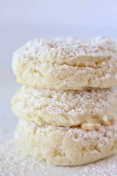 three powdered sugar cookies stacked on top of each other