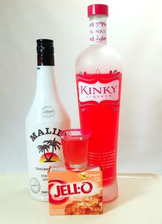 a bottle of liquor next to a carton of jello and a glass filled with liquid