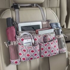 the back seat pocket is filled with various items and gadgets, including cell phones